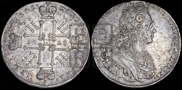 Рубль 1728 года (голова разделяет надпись, в венке бант)