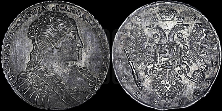 Рубль 1734 года (голова меньше, крест короны делит надпись, одинарная складка над корсажем)